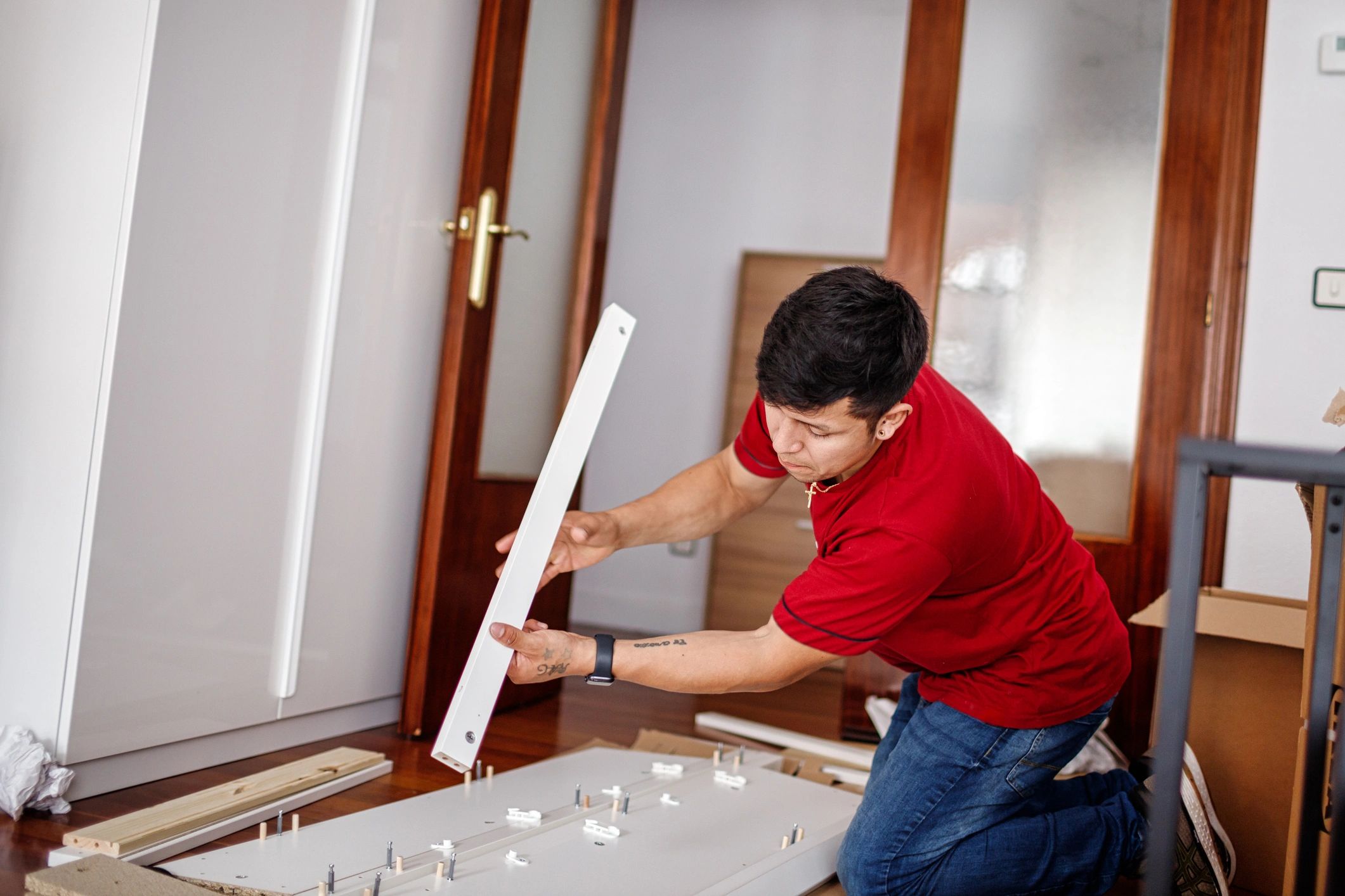 Technician installing door panel in residential interior